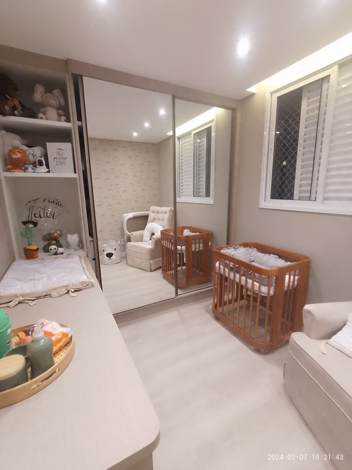 Quarto de bebê ambientado com marcenaria e iluminação indireta